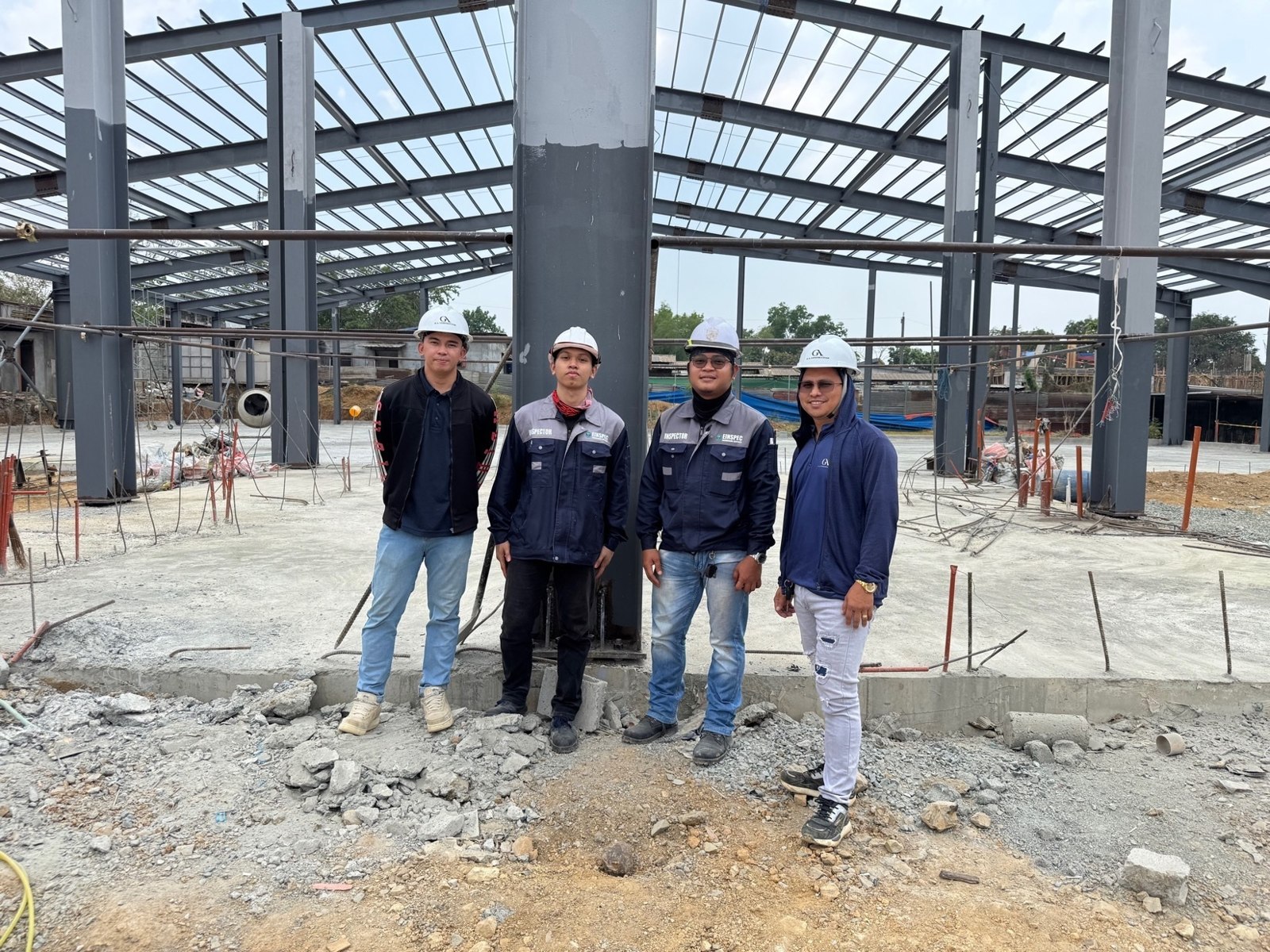 Team members on a logistics warehouse site with structural steel framing